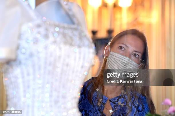 Royal Collection Trust Curator Caroline de Guitut views HRH Princess Beatrice of York's wedding dress on display at Windsor Castle on September 23,...