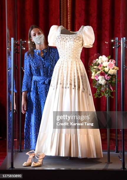 Royal Collection Trust Curator Caroline de Guitut views HRH Princess Beatrice of York's wedding dress on display at Windsor Castle on September 23,...