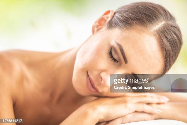 a beautiful woman relaxing in a beauty salon spa or wellnes. - perfect female body shape fotografías e imágenes de stock