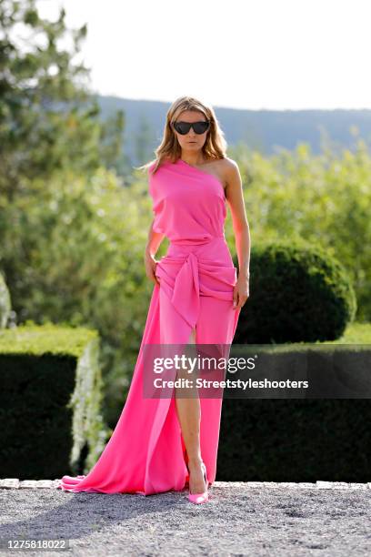 Influencer Gitta Banko, wearing a pink evening dress by Rhea Costa and pink colored pumps by Balenciaga during a street style shooting at Manoir de...