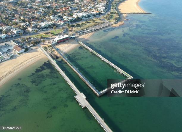 bathing area at the beach alongside the pier - boardwalk australia stock pictures, royalty-free photos & images