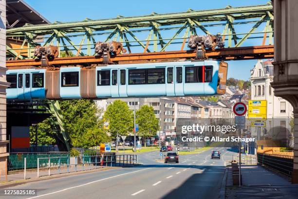 schwebebahn train crossing a street in wuppertal germany - wuppertal bildbanksfoton och bilder