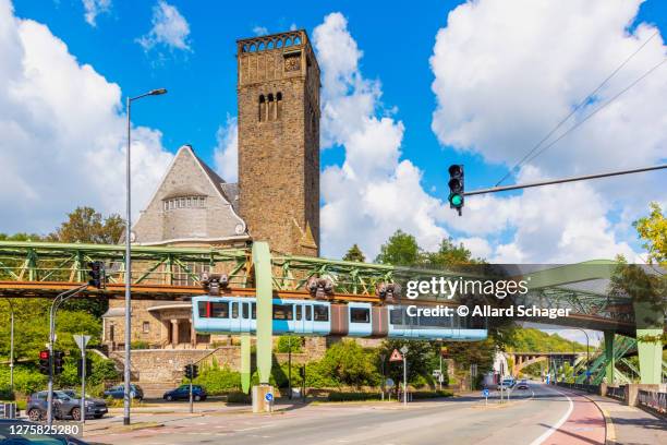 schwebebahn train passing a church in wuppertal germany - wuppertal bildbanksfoton och bilder