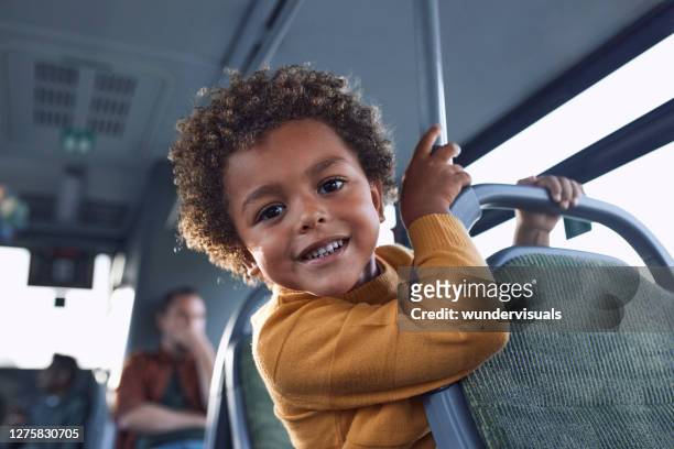 african-american little boy looking at the camera inside public bus - play bus stock pictures, royalty-free photos & images
