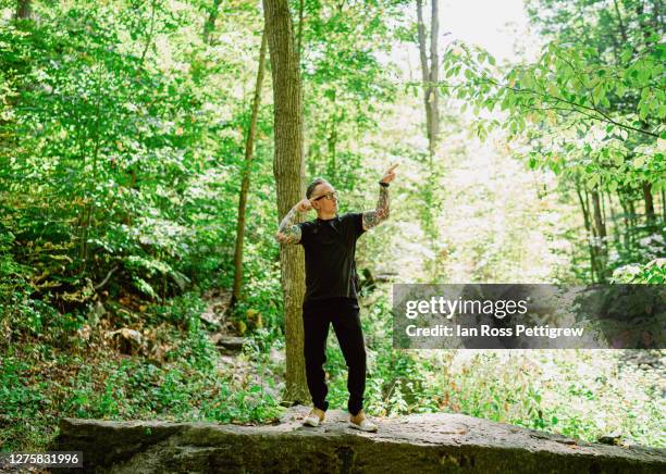 middle-aged man hiking in forest - hiking mature man stock pictures, royalty-free photos & images