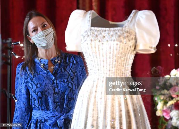 Royal Collection Trust Curator Caroline de Guitut views HRH Princess Beatrice of York's wedding dress on display at Windsor Castle on September 23,...