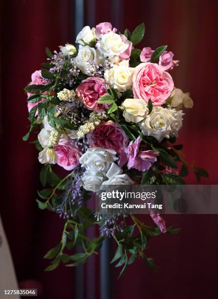 Princess Beatrice of York's wedding bouquet and wedding dress on display at Windsor Castle on September 23, 2020 in Windsor, England. Princess...