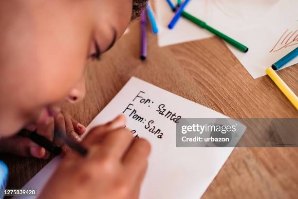 girl writes the letter to santa claus - child writing letter to santa stock pictures, royalty-free photos & images