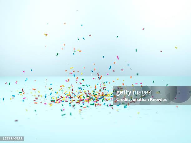 confetti sprinkles falling - rainbow confetti stock pictures, royalty-free photos & images