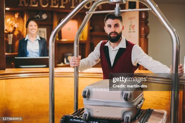 bellhop carrying luggage - bus boy stock pictures, royalty-free photos & images