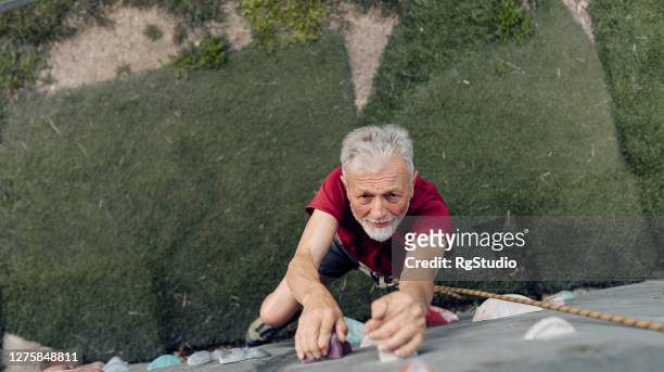 senior sport climber enjoying on his training - senior people training imagens e fotografias de stock