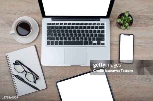 office stuff with notepad, laptop, smartphone and coffee cup mouse notepad top view shot. - computer mouse table stock pictures, royalty-free photos & images