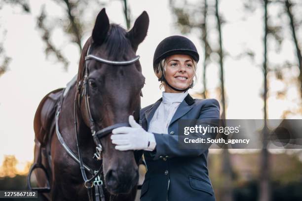 beautiful woman horse rider and her horse - jockey uniform stock pictures, royalty-free photos & images