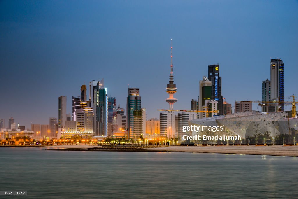 Illuminated Liberation Tower And Famous Landmark City Buildings Of Kuwait By The Sea, Kuwait City, Capital Of Kuwait