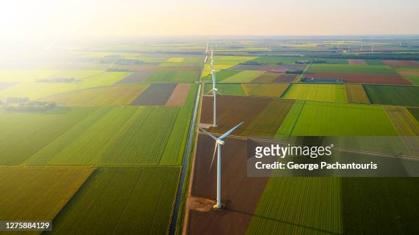 aerial view of wind turbines in a row and bright sun - dutch culture stock pictures, royalty-free photos & images