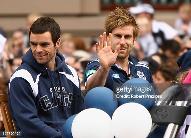 Matthew Scarlett and Tom Lonergan of the Cats thank fans during the AFL Grand Final parade on September 30, 2011 in Melbourne, Australia.