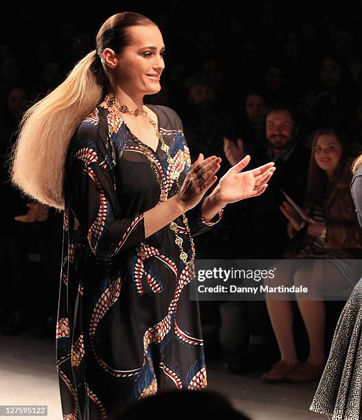 Yasmin Le Bon walks the catwalk, watched by husband Simon Le Bon and daughter Saffron Le Bon from the front row at the Issa London show during...