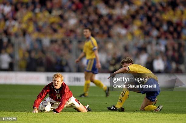 Paul Scholes of England is brought down by Stefan Schwarz of Sweden during the European Championship qualifier at the Rasunda Stadium in Stockholm,...