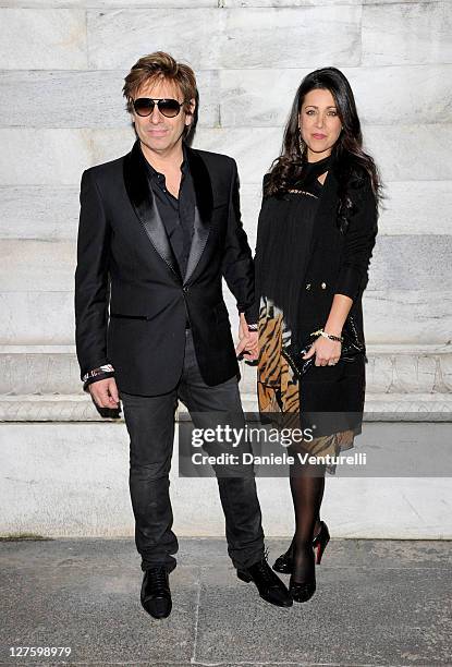 Roger Taylor and Gisella Bernales attend the Roberto Cavalli fashion show as part of Milan Fashion Week Womenswear Autumn/Winter 2011 on February 26,...