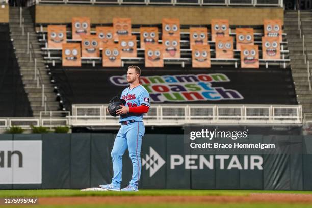 September 22: Ryan Jeffers of the Minnesota Twins looks on in front of the Cinnamon Toast Crunch Emoji fan section against the Detroit Tigers on...