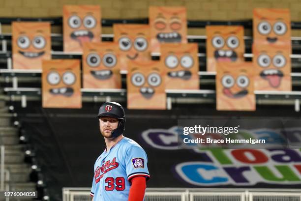 September 22: Ryan Jeffers of the Minnesota Twins looks on in front of the Cinnamon Toast Crunch Emoji fan section against the Detroit Tigers on...