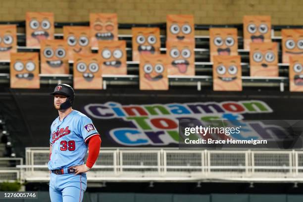 September 22: Ryan Jeffers of the Minnesota Twins looks on in front of the Cinnamon Toast Crunch Emoji fan section against the Detroit Tigers on...