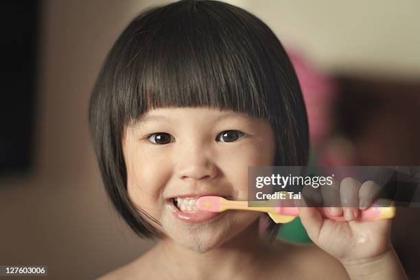 girl brushing her teeth - toothbrush ストックフォトと画像
