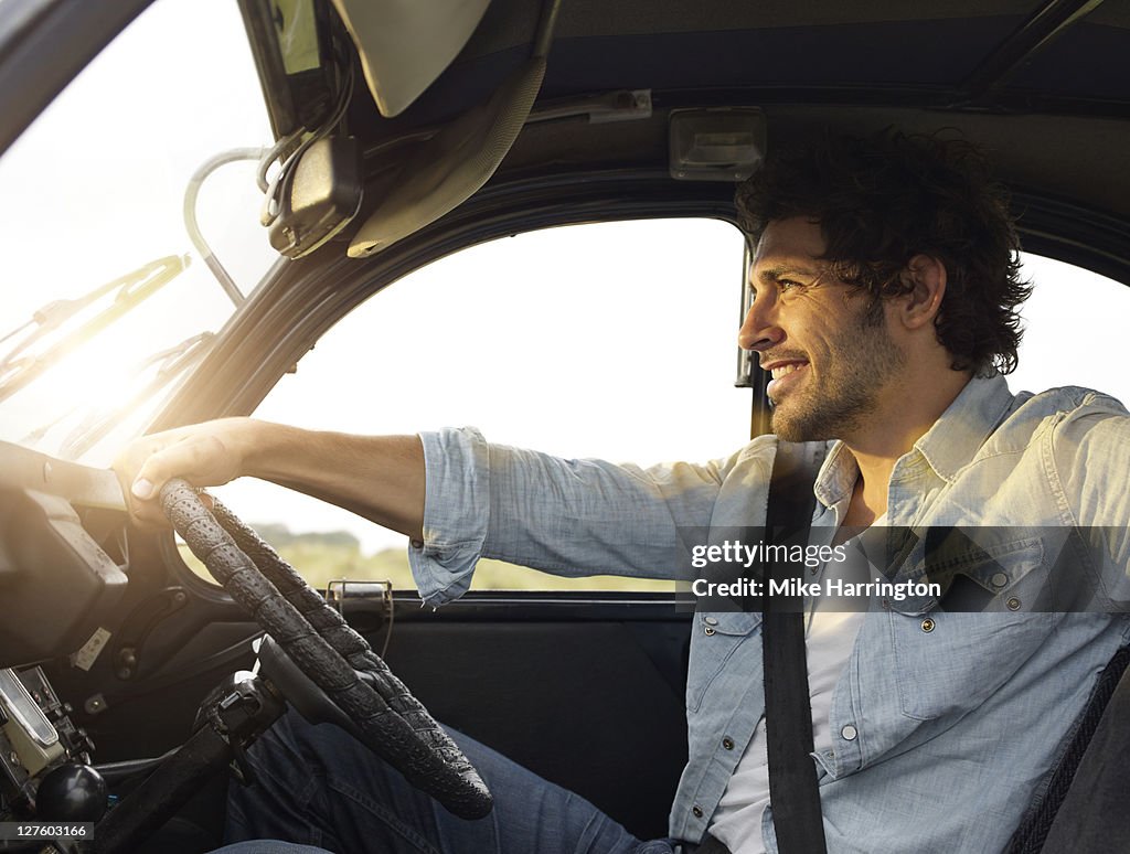 Young man sitting in car