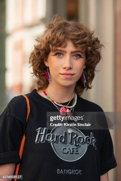 Actor Eve Byrne wears a Hard Rock cafe T shirt and David Bowie tribute earrings during LFW September 2020 at on September 18, 2020 in London, England.