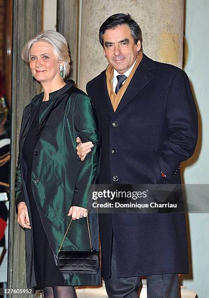 French Prime minister François Fillon and his wife Penelope pose as they arrive to the State Dinner At Elysee Palace Honouring South African...