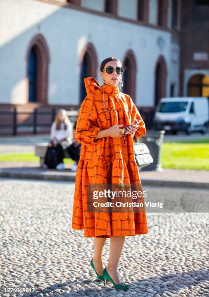 Guest is seen wearing orange dress outside Alberta Ferretti during the Milan Women's Fashion Week on September 23, 2020 in Milan, Italy.