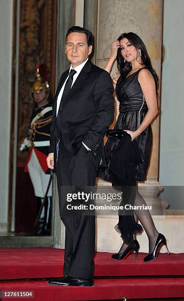 French minister for industry Energy and the Digital Economy Eric Besson and his wife Yasmine pose as they arrive to the State Dinner At Elysee Palace...