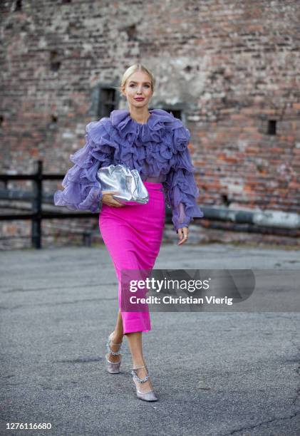 Leonie Hanne seen wearing purple top and pink skirt, silver Bottega Veneta bag outside Alberta Ferretti during the Milan Women's Fashion Week on...