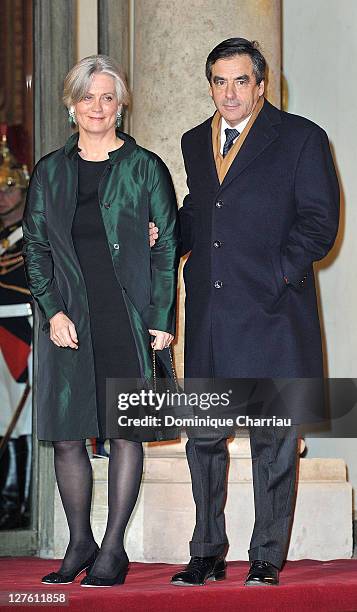 French Prime minister François Fillon and his wife Penelope pose as they arrive to the State Dinner At Elysee Palace Honouring South African...