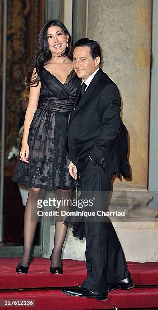French minister for industry Energy and the Digital Economy Eric Besson and his wife Yasmine pose as they arrive to the State Dinner At Elysee Palace...
