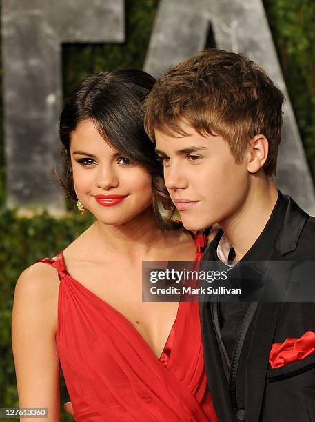 Singer-actress Selena Gomez and singer Justin Bieber arrive at the Vanity Fair Oscar party hosted by Graydon Carter held at Sunset Tower on February...