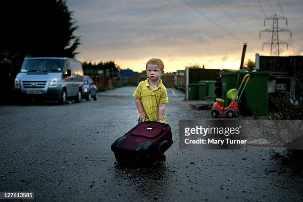 Dennis Sheridan, aged 4, plays with a suitcase at Dale Farm travellers camp on September 11, 2011 near Basildon, England. Hundreds of travellers...