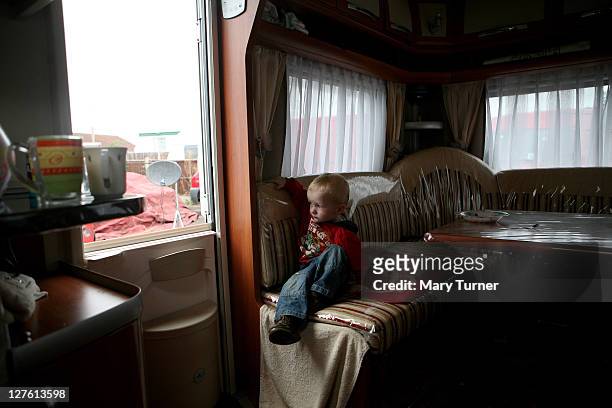 Tom Sherdidan sits in his family's caravan at Dale Farm Travellers camp on September 20, 2011 near Basildon, England. Hundreds of travellers remain...