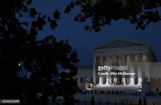 Members of the public pay their respects beneath the casket of Associate Justice Ruth Bader Ginsburg into the evening at the U.S. Supreme Court, on...