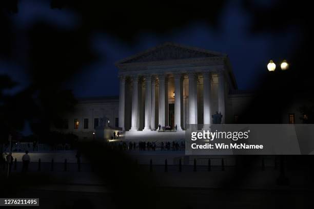 Members of the public pay their respects beneath the casket of Associate Justice Ruth Bader Ginsburg into the evening at the U.S. Supreme Court, on...