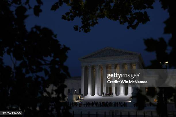 Members of the public pay their respects beneath the casket of Associate Justice Ruth Bader Ginsburg into the evening at the U.S. Supreme Court, on...