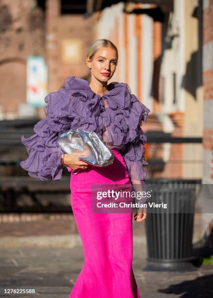 Leonie Hanne seen wearing purple top and pink skirt, silver Bottega Veneta bag outside Alberta Ferretti during the Milan Women's Fashion Week on...