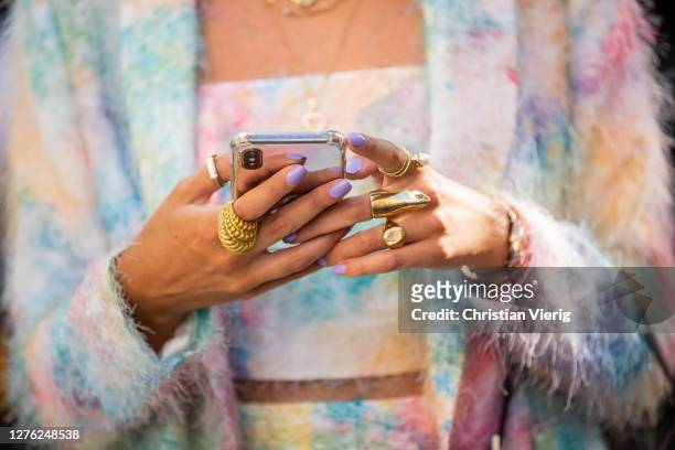 Guest is seen with phone jewelery outside Fendi during the Milan Women's Fashion Week on September 23, 2020 in Milan, Italy.