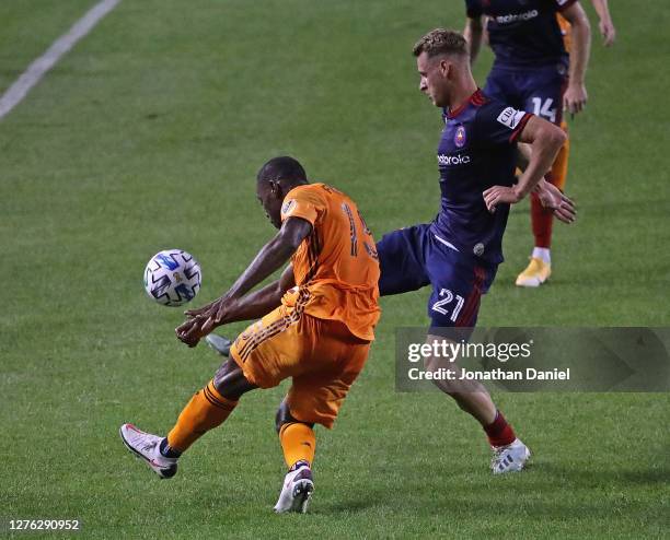 Fabian Herbers of Chicago Fire FC knocks the ball away from Maynor Figueroa of Houston Dynamo at Soldier Field on September 23, 2020 in Chicago,...