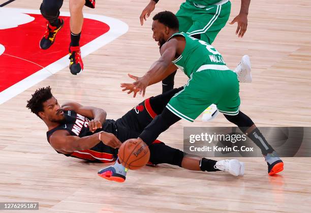 Jimmy Butler of the Miami Heat passes the ball against Kemba Walker of the Boston Celtics during the first quarter in Game Four of the Eastern...