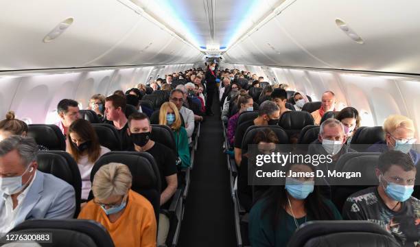 Passengers and crew onboard a Qantas Boeing 737-800, flight number QF735 from Sydney to Adelaide at Sydney Airport on September 24, 2020 in Sydney,...