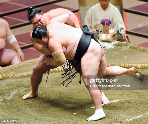 Ozeki Asanoyama throws Okinoumi to win on day eleven of the Grand Sumo Autumn Tournament at Ryogoku Kokugikan on September 23, 2020 in Tokyo, Japan.