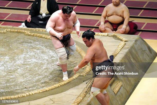 Terunofuji pushes Myogiryu out of the ring to win on day eleven of the Grand Sumo Autumn Tournament at Ryogoku Kokugikan on September 23, 2020 in...