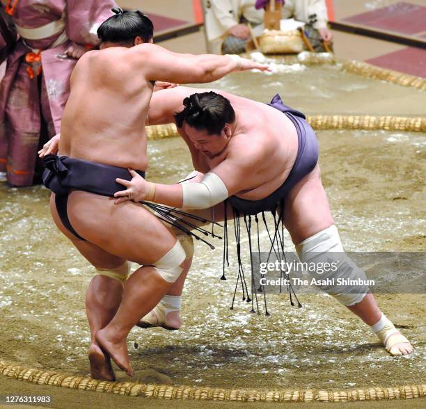 Terunofuji pushes Myogiryu out of the ring to win on day eleven of the Grand Sumo Autumn Tournament at Ryogoku Kokugikan on September 23, 2020 in...