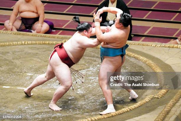 Takanosho pushes Tamawashi out of the ring to win on day eleven of the Grand Sumo Autumn Tournament at Ryogoku Kokugikan on September 23, 2020 in...